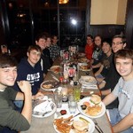 Photo of trombone students around a table sharing a meal during Fall 2011.